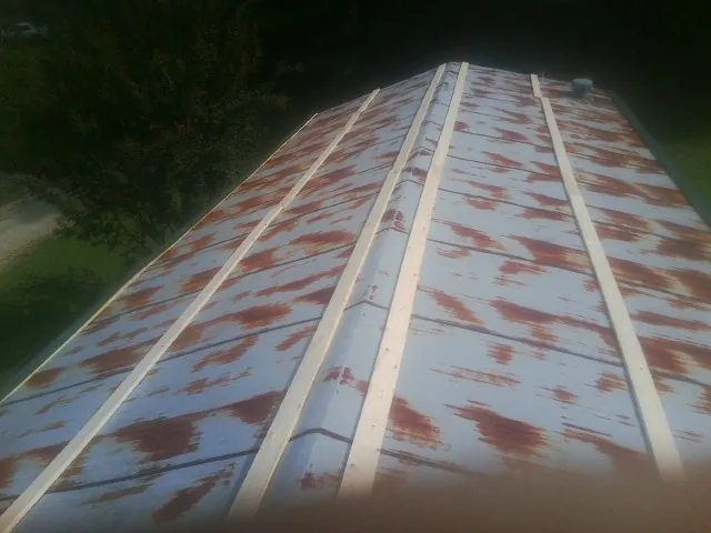 Rusted metal roof panels with new wood purlins before replacement — Storm Damage Roof Repair in Westchester by Roofing Brothers
