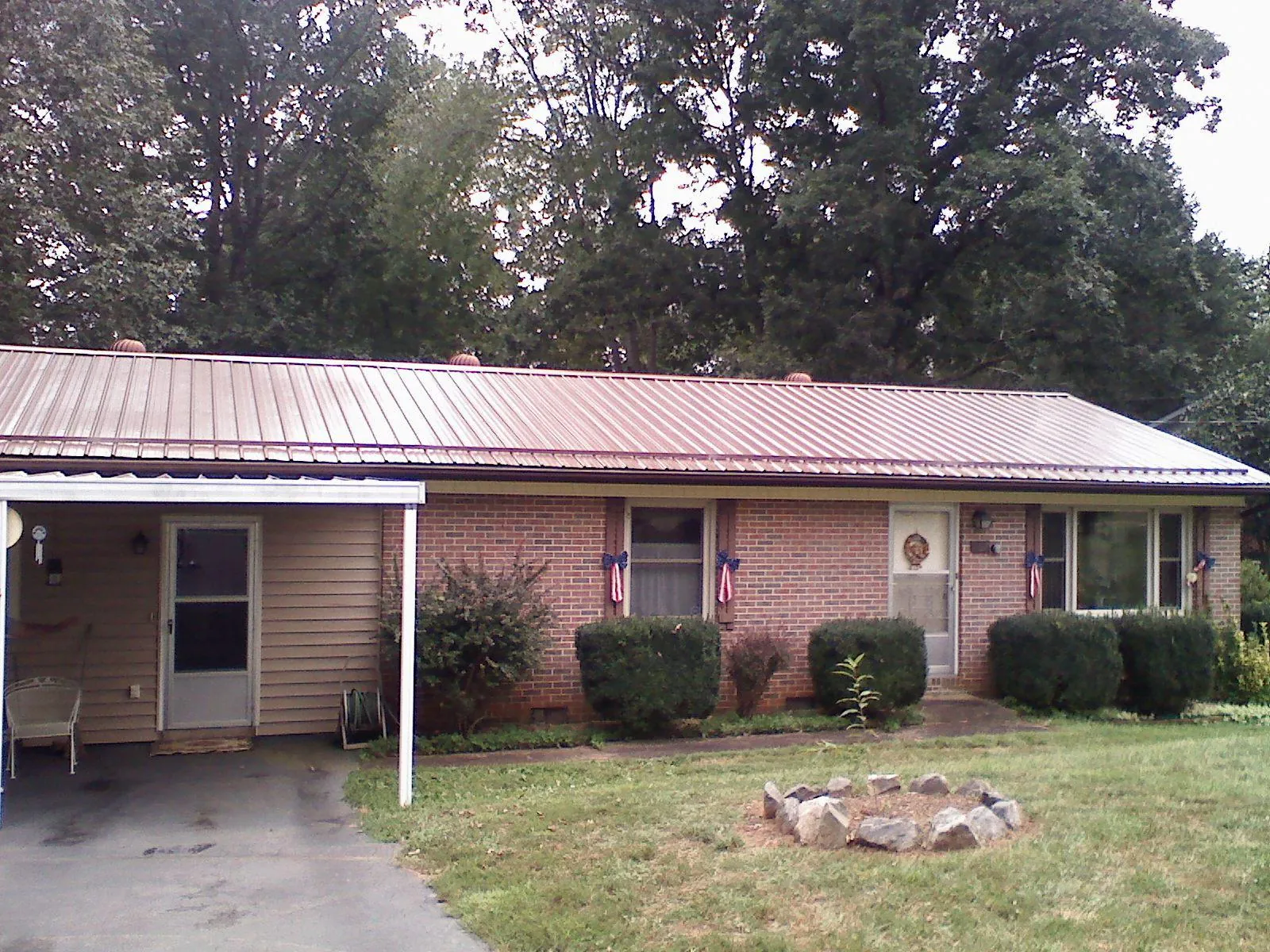 Bronze metal roof and carport on a brick ranch home — Roof Repair work by our crew in Westchester